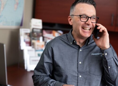 Service provider talking on the phone at his office desk