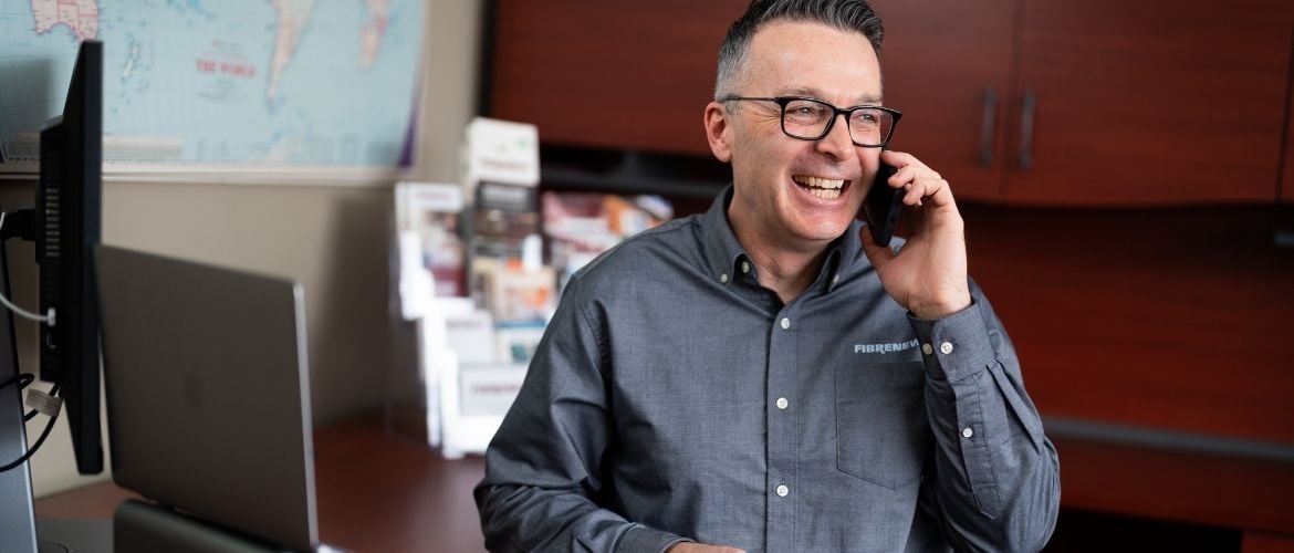 Service provider talking on the phone at his office desk