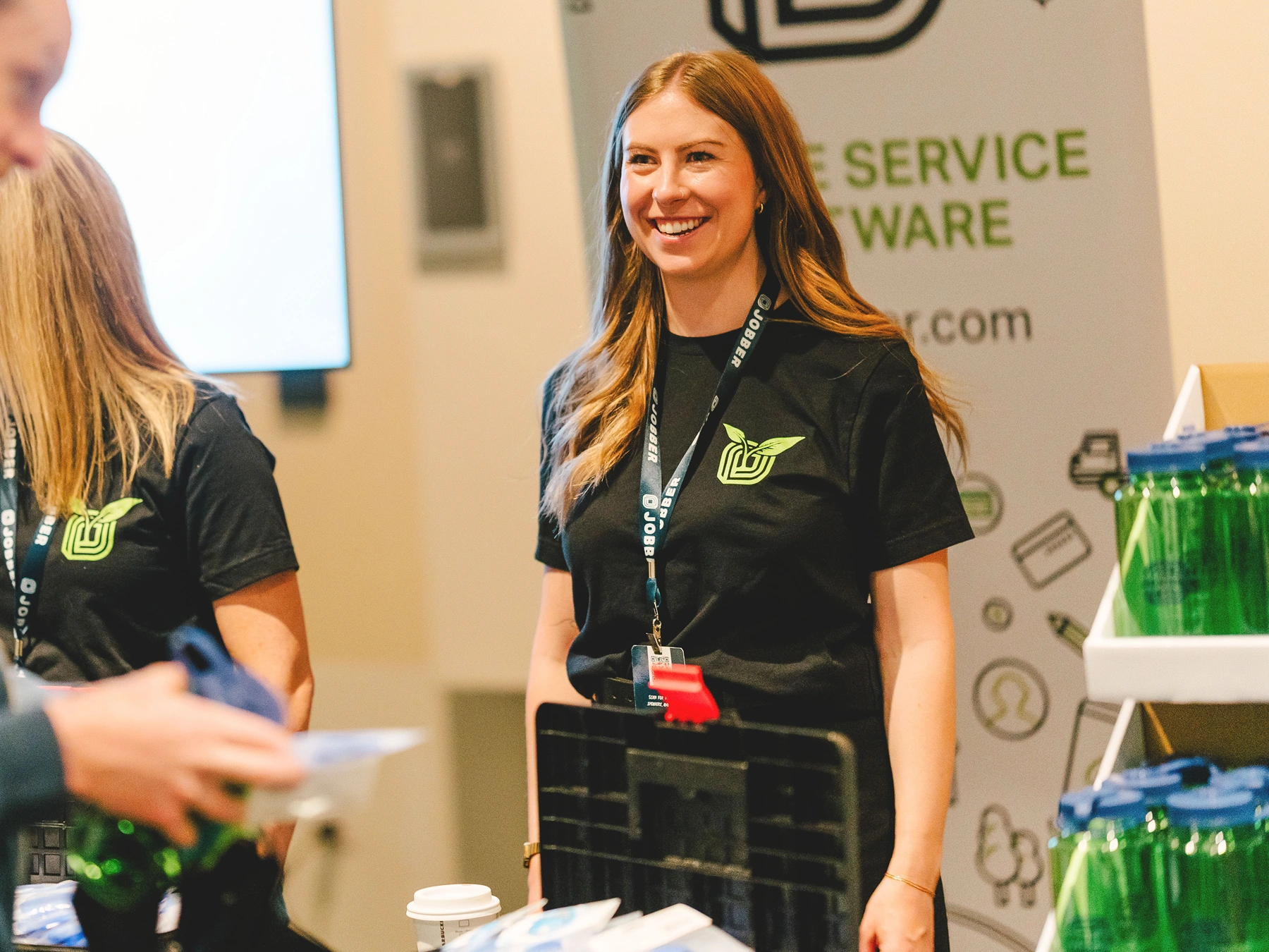 A Jobber employee standing at a trade show