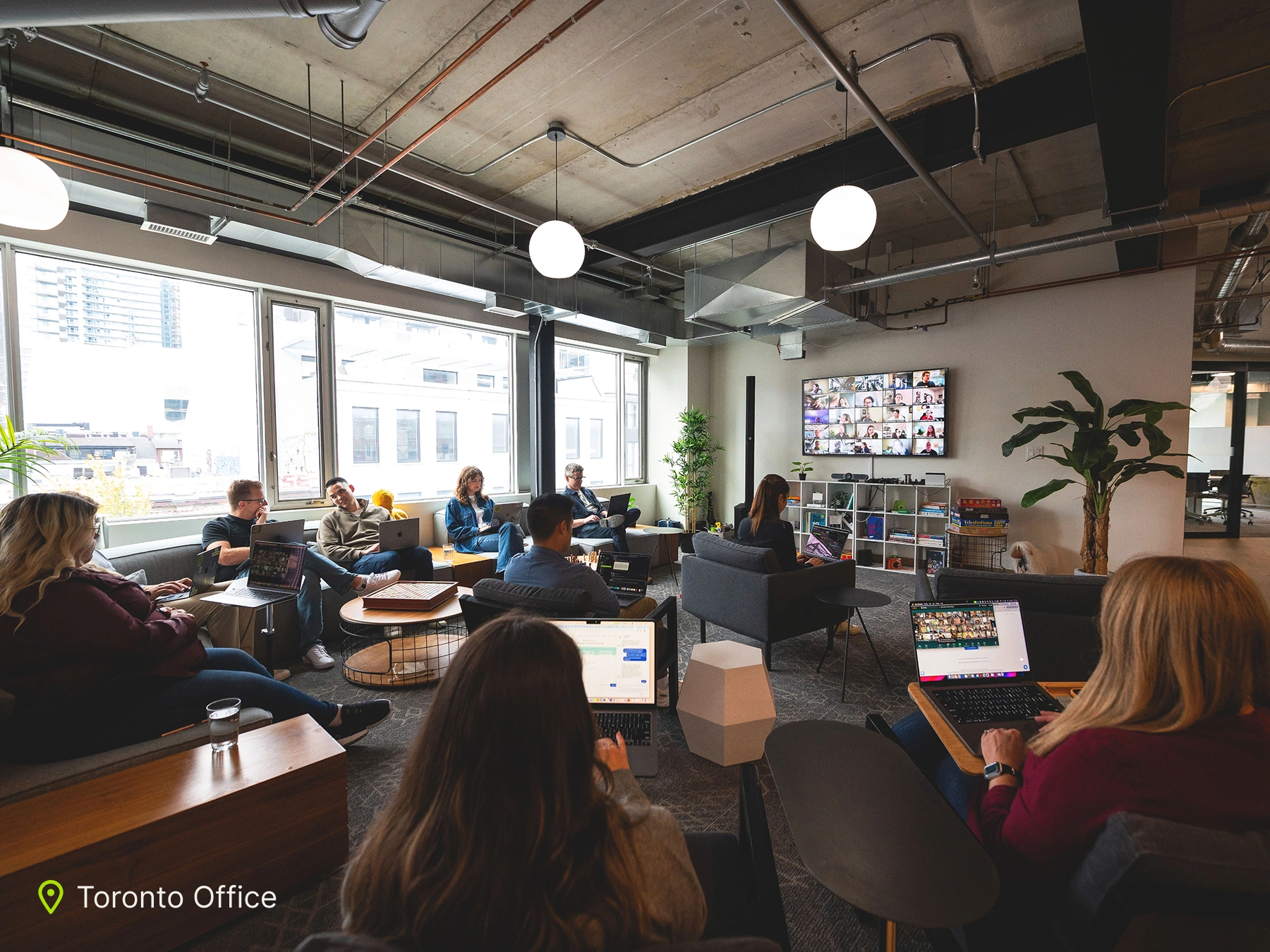 Several Jobber employees sitting in an office.