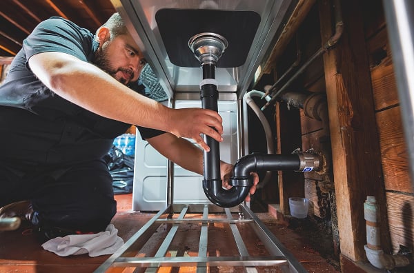 A person fixing a sink