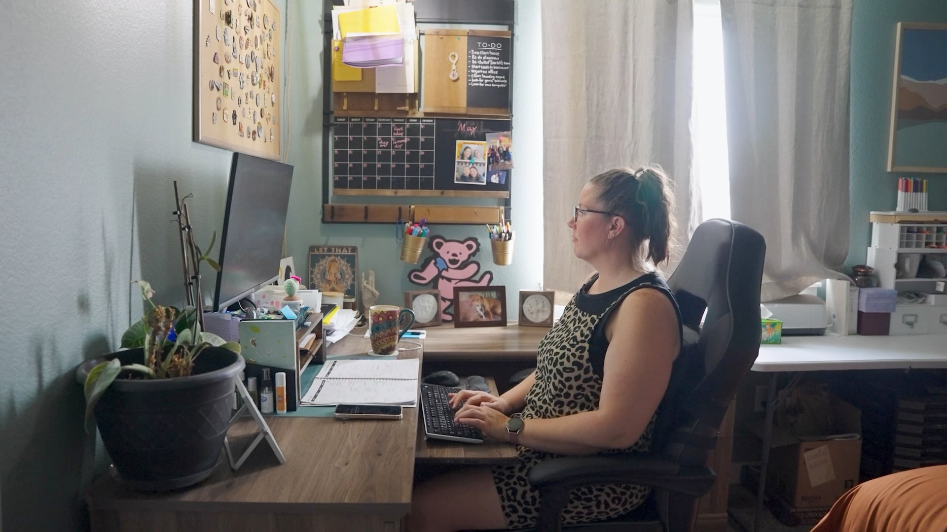 Tracy Schuldt works at a desktop computer from her home office.