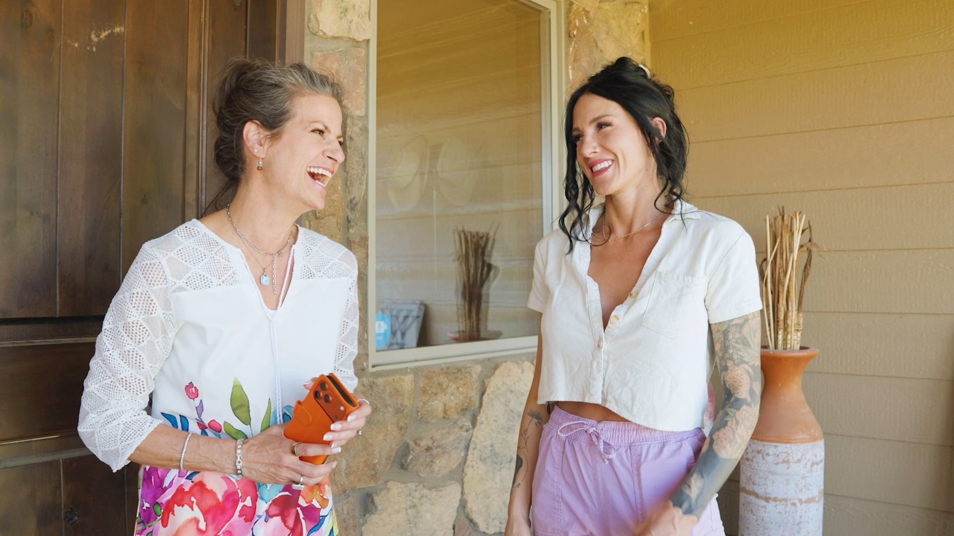 Savannah Revis smiles while talking with a homeowner outside a residence.