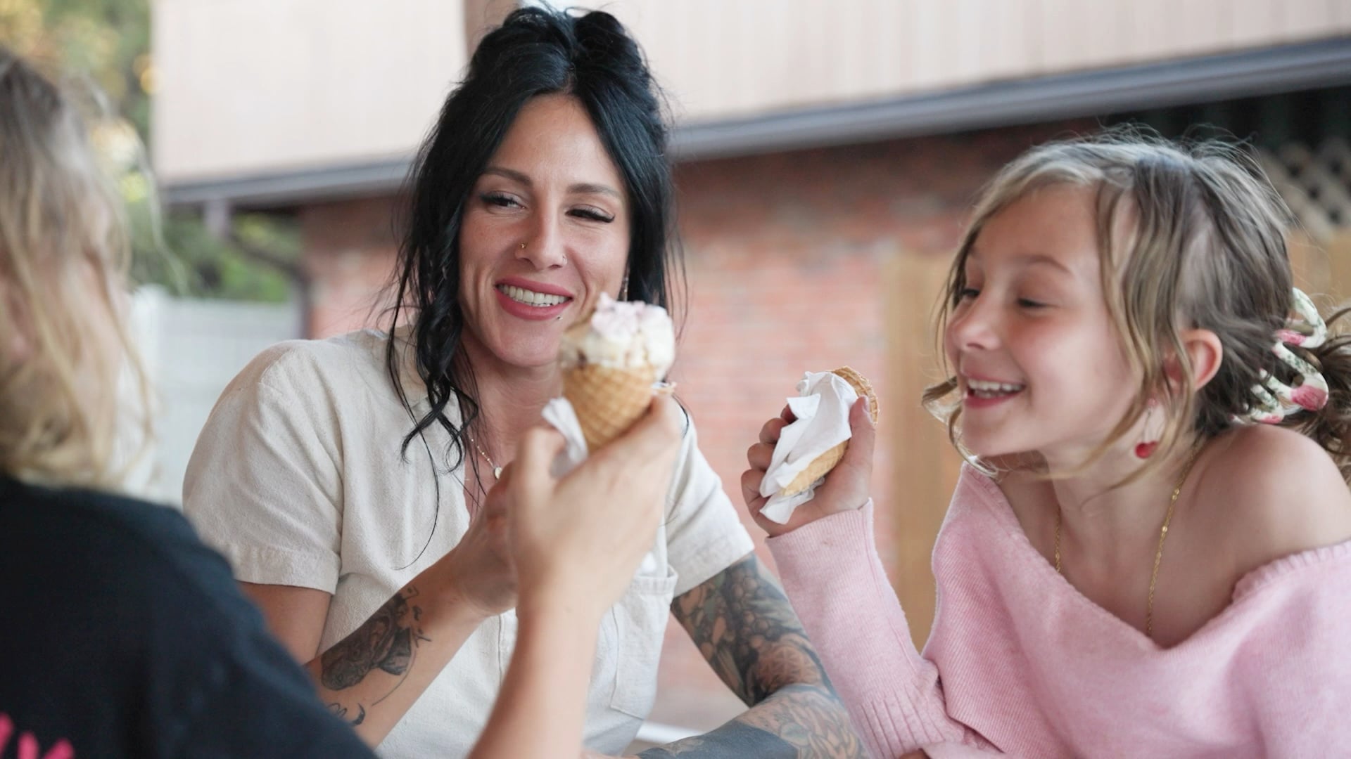 Earth Love Cleaning owner Savannah Revis smiles while enjoying ice cream with her kids.